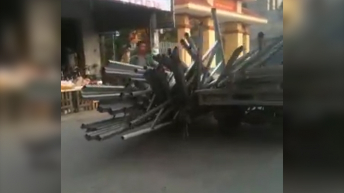 Những thanh sắt trên xe ba bánh đổ tràn xuống đường ở Nam Định